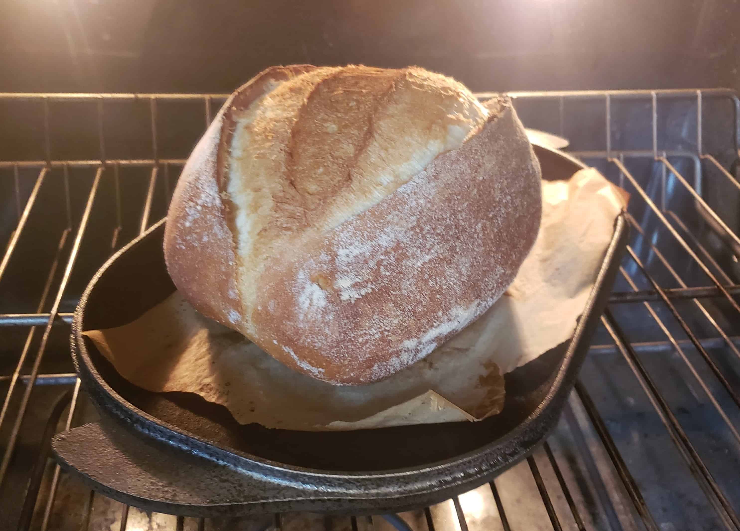 Bake – 3 Bread baking in an oven with parchment on bottom