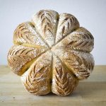 Finished Loaf of Pumpkin Boule Resting on Cutting Board